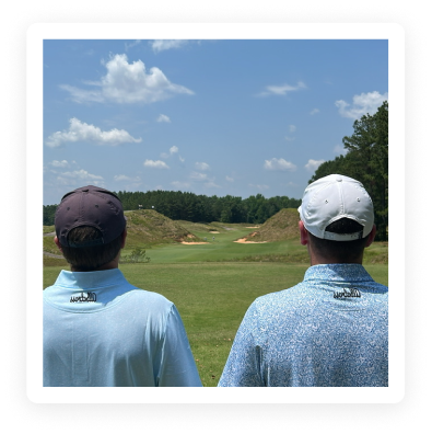 Two guys looking at a golf course